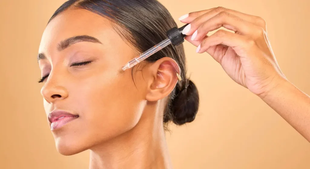 beautiful face with dropper of serum